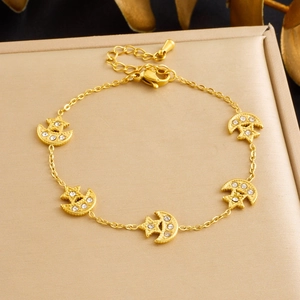 Bracelet en acier inoxydable doré avec breloques lune et étoile et cristaux brillants