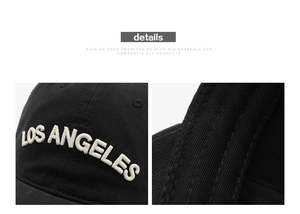 Close-up of white 3D Los Angeles embroidery and neat stitching on black cotton cap
