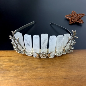 Macro view of crystal crown featuring silver metal branches and crescent moon ornaments