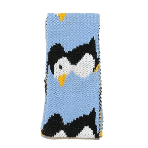 Detailed close-up of blue knit fabric showing intricate penguin jacquard pattern and texture