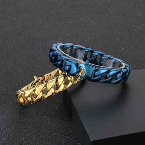 Polished 15mm Cuban link stainless steel bracelets in gold and blue on black background