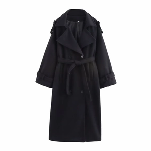 Detail of black double-breasted long wool coat with matching belt and cuff straps