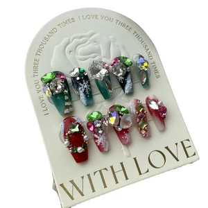 Handmade Christmas press-on nails set with red and green festive 3D snowflake charms