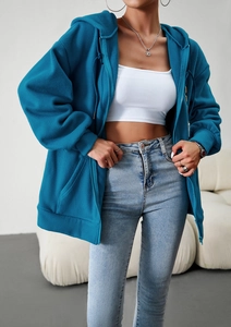 Detail view of blue zip-up hoodie featuring warm fleece lining and soft hood fabric