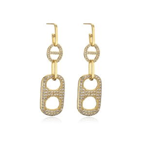 Macro shot of gold-plated geometric link earrings with pavé cubic zirconia setting