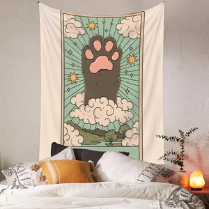Cat paw tarot tapestry hanging on white bedroom wall with plants and cozy lighting