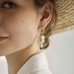 Elegant 14K gold-plated wheat ear stud earrings with delicate pearl tassel drop on a model