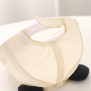 Detail of adjustable Velcro strap on cream baby sun hat with high-quality stitching