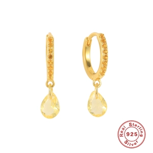 Detail of S925 sterling silver hoop earrings with pave diamonds and yellow teardrop gem