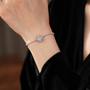 Detail of silver clover zircon bracelet on wrist with elegant sparkling stones