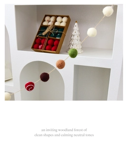 Detailed view of handcrafted wool felt Christmas balls with snowflake embroidery and twine