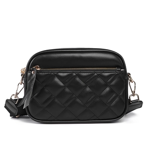 Classic black quilted crossbody bag with golden zipper and wide nylon shoulder strap