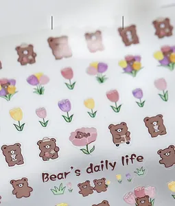 Close-up of cute cartoon bear and colorful tulip stickers for nail art and planners