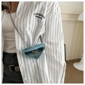 Détail du sac triangle bleu métallisé avec boucle nœud argent et chaîne serpent