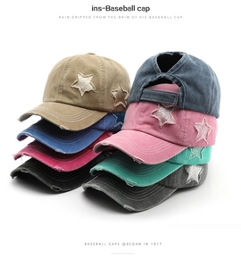 Detail of vintage washed baseball caps with star sequins and ponytail hole design