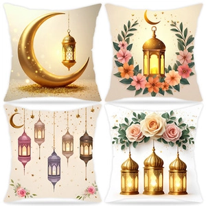 Detail of four square pillow covers with gold crescent moon and lantern patterns