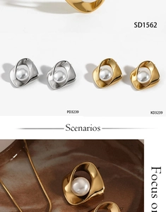Detail of twisted metal irregular earring with white pearl in gold and silver finish