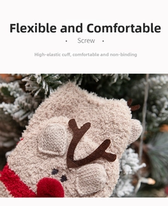 Close-up of thick coral fleece Christmas socks with reindeer antlers and red pom pom detail