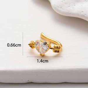 Macro shot of gold cupid arrow cartilage cuff with heart cubic zirconia and dimensions