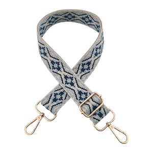 Macro shot of adjustable jacquard strap with blue geometric pattern and gold hardware