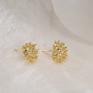 Textured 18K gold plated heart stud earrings with 925 silver needles on stone surface