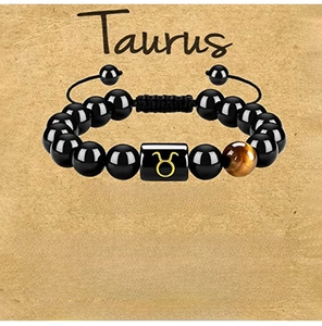 Detailed view of Taurus bracelet with black beads, tiger eye stone and zodiac card