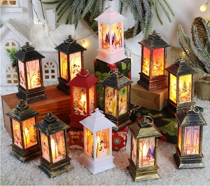 Close-up of vintage Christmas LED lanterns with warm light and festive illustrations
