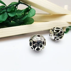 Vintage hollow silver alloy beads with intricate ethnic patterns for jewelry making