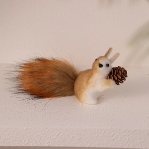 Realistic squirrel ornament with flocking texture holding a natural pine cone for decor