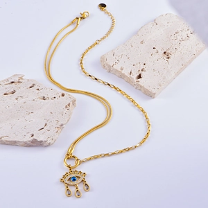 Golden double-layer chain necklace with devil's eye pendant and teardrop charms