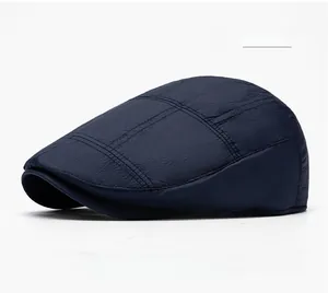 Detail shot of navy blue winter newsboy cap showing fine fabric texture and stitching