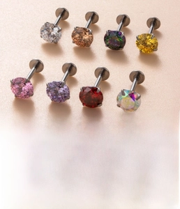 Detail view of 1.2x8mm titanium labret studs with eight different colored zircon stones