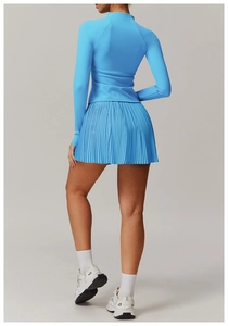 Rear view of bright blue athletic set with high-waist pleated skirt and snug long-sleeve top