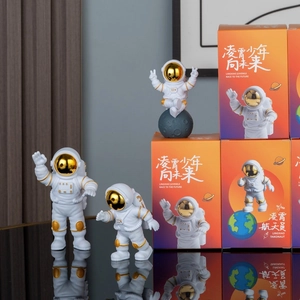 Astronaut figurines with golden visors in various poses and orange gift box set