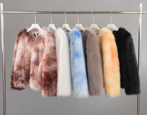 Detailed row of assorted colorful faux fur jackets on hangers showing texture