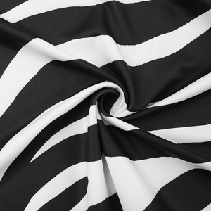 Close-up macro of soft black and white zebra print knit fabric with spiral texture detail