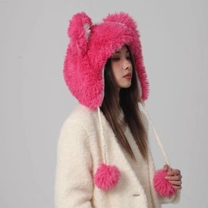Pink plush earflap hat with furry pom-poms and cute animal ears for winter warmth