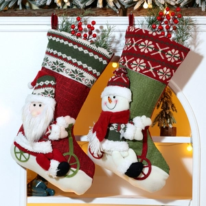 Detail of burlap Christmas stockings featuring 3D Santa and Snowman with pine decorations
