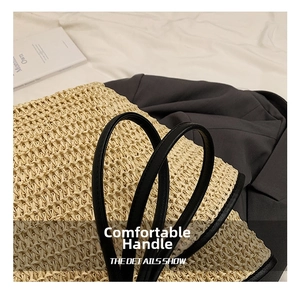 Detailed close-up of woven straw texture with contrasting black leather handle and edging
