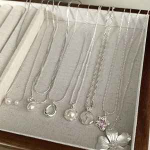 Minimalist silver necklaces set featuring pearls, sapphire, and floral pendants
