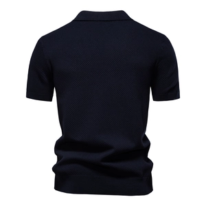 Back view of navy blue knit polo shirt featuring unique honeycomb textured fabric