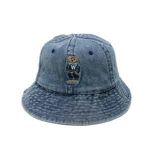 Close-up of a blue washed denim bucket hat featuring detailed teddy bear embroidery