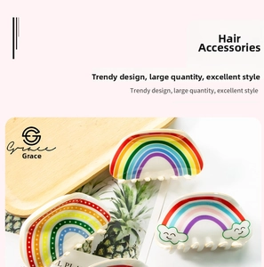 Detailed close-up of rainbow hair claw clips with colorful gradients and cloud accents