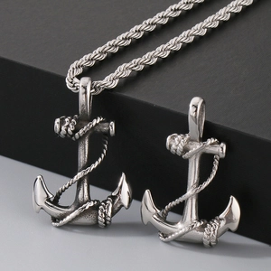 Detailed close-up of a silver nautical anchor pendant with rope detail on a twisted chain