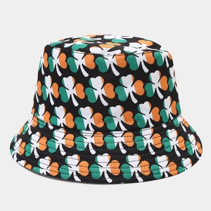 Detail of shamrock pattern on a black fisherman hat with green white and orange clover print
