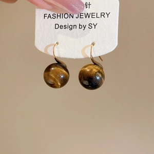 Tiger eye bead earrings with gold hooks displayed on a white fashion jewelry card