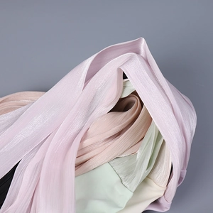 Close-up of pleated sun protection sleeves in lavender, mint, and cream breathable fabric