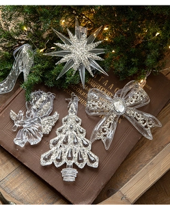 Detailed view of clear acrylic Christmas ornaments with silver glitter on vintage books