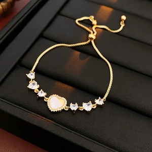 Macro detail of gold-plated heart bracelet with zircon stones and adjustable slider