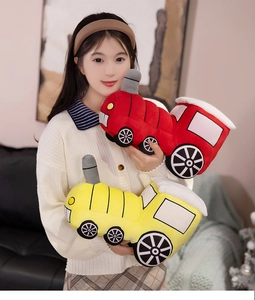 Close-up of soft plush steam train doll with cute chimney and wheels being hugged